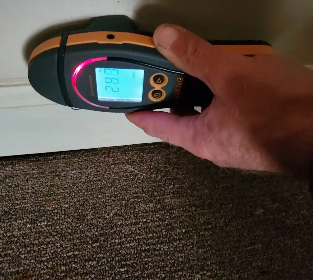 Moisture detection at baseboard during Storm Damage Restoration in Barnhart